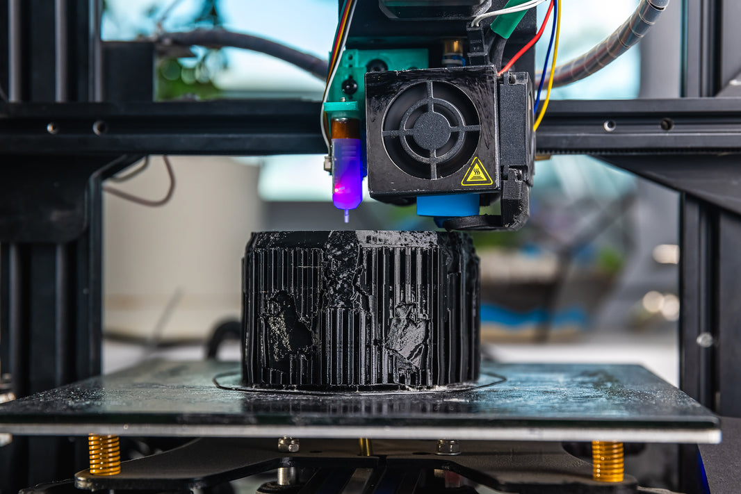 A 3D printer actively printing a part, illustrating the difference between general-purpose and engineering-grade filament materials